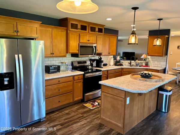 a kitchen with a sink a stove a refrigerator and a microwave