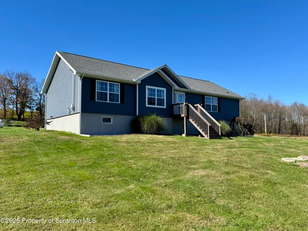 a house with huge green field in front of it