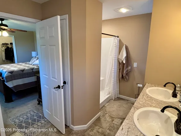 a bathroom with a granite countertop sink a large mirror and a bathtub