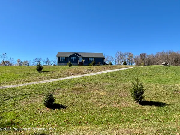 a view of a big yard with an buildings in the background