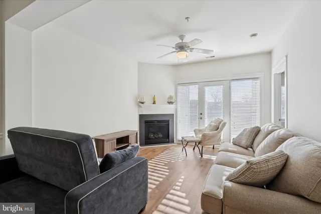 a living room with furniture a fireplace and a chandelier