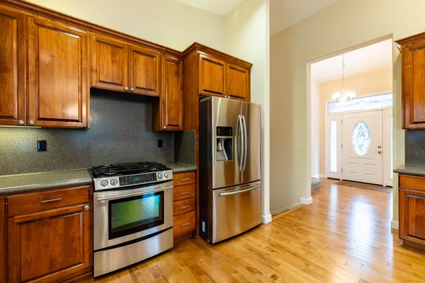 a view of a hallway with wooden floor and staircase
