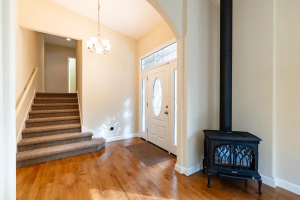 a living room with furniture a flat screen tv and a pool table