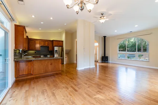 a view of kitchen with sink and refrigerator