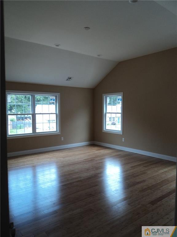 38 Markham Road Edison, NJ 08817 - Photo 8 of 9 an empty room with wooden floor and windows