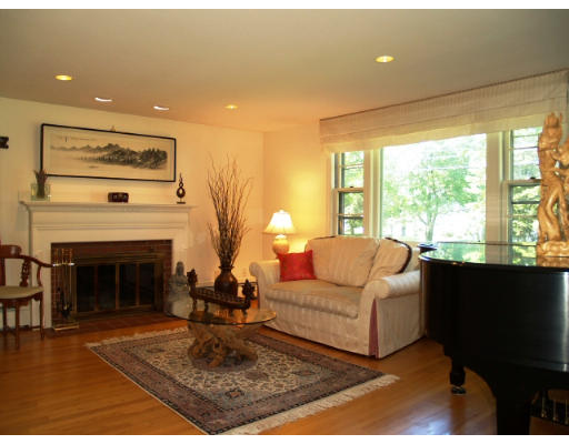 6 Ash Street Lexington, MA 02421 - Photo 3 of 18 a living room with furniture a large window and a fireplace