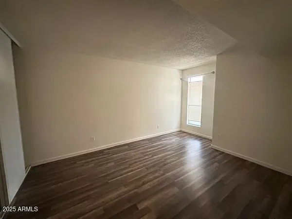 a view of an empty room and wooden floor