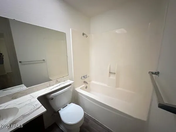 a bathroom with a toilet a sink and bathtub