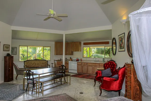 a living room with furniture a window and a flat screen tv