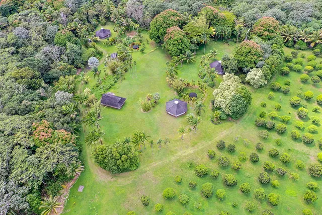 an aerial view of a house with a yard