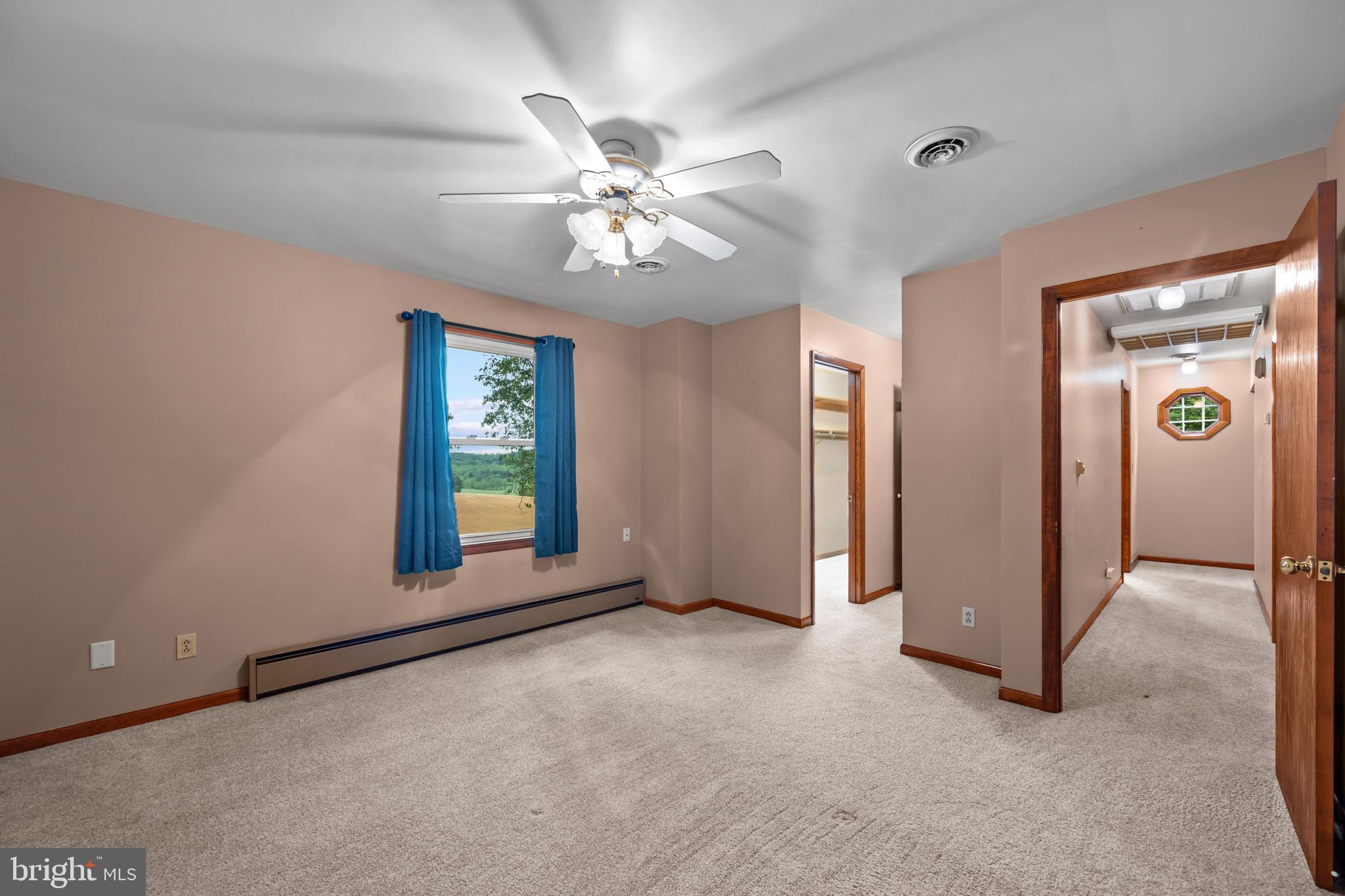 5313 Wentz Road Manchester, MD 21102 - Photo 10 of 51 an empty room with chandelier fan and windows