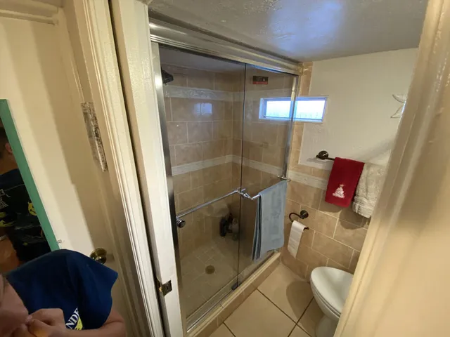 a bathroom with a shower and toilet
