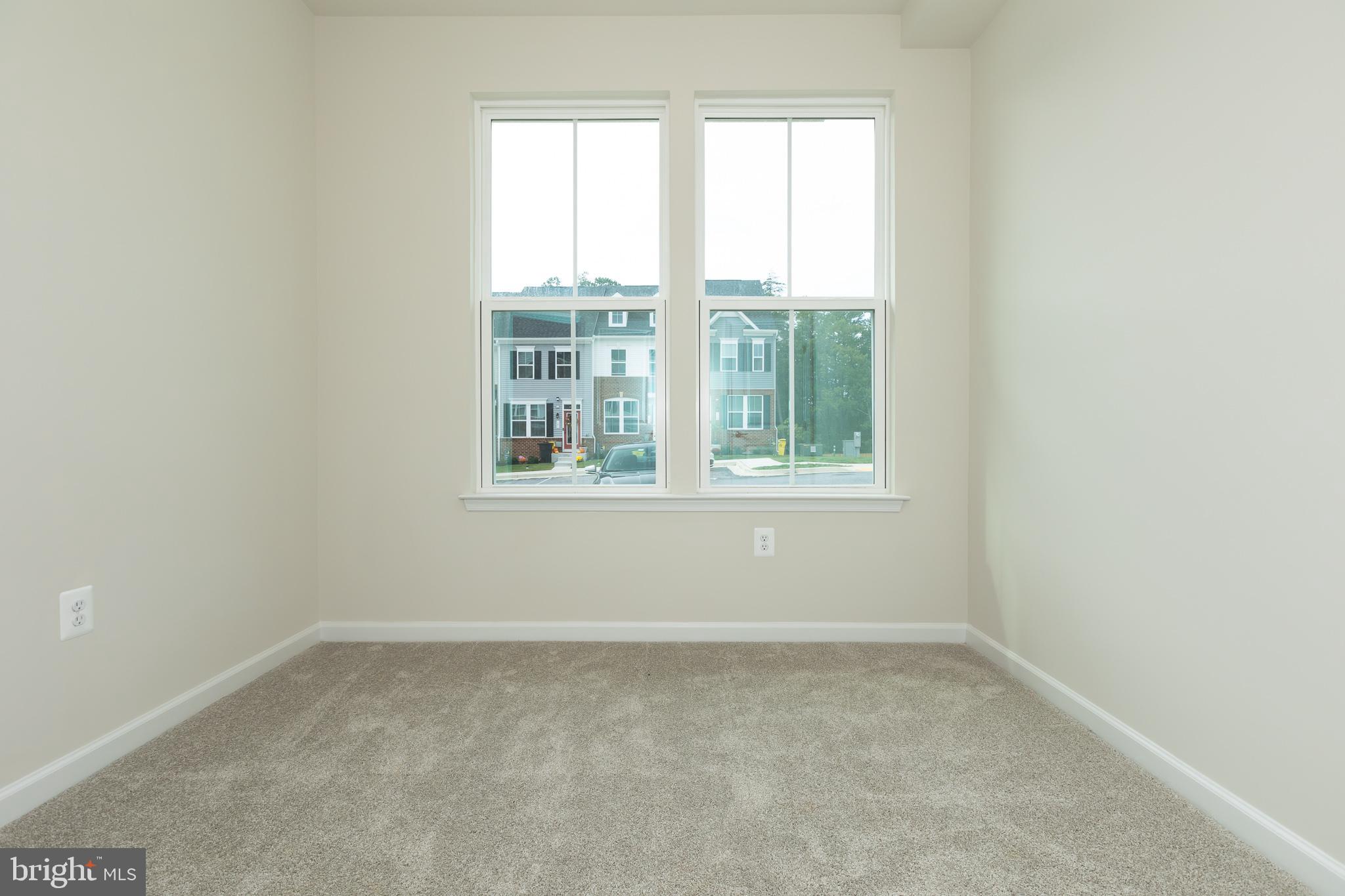 180 Woodgate Circle, Unit CLARENDON3 Pasadena, MD 21122 - Photo 11 of 47 an empty room with a window
