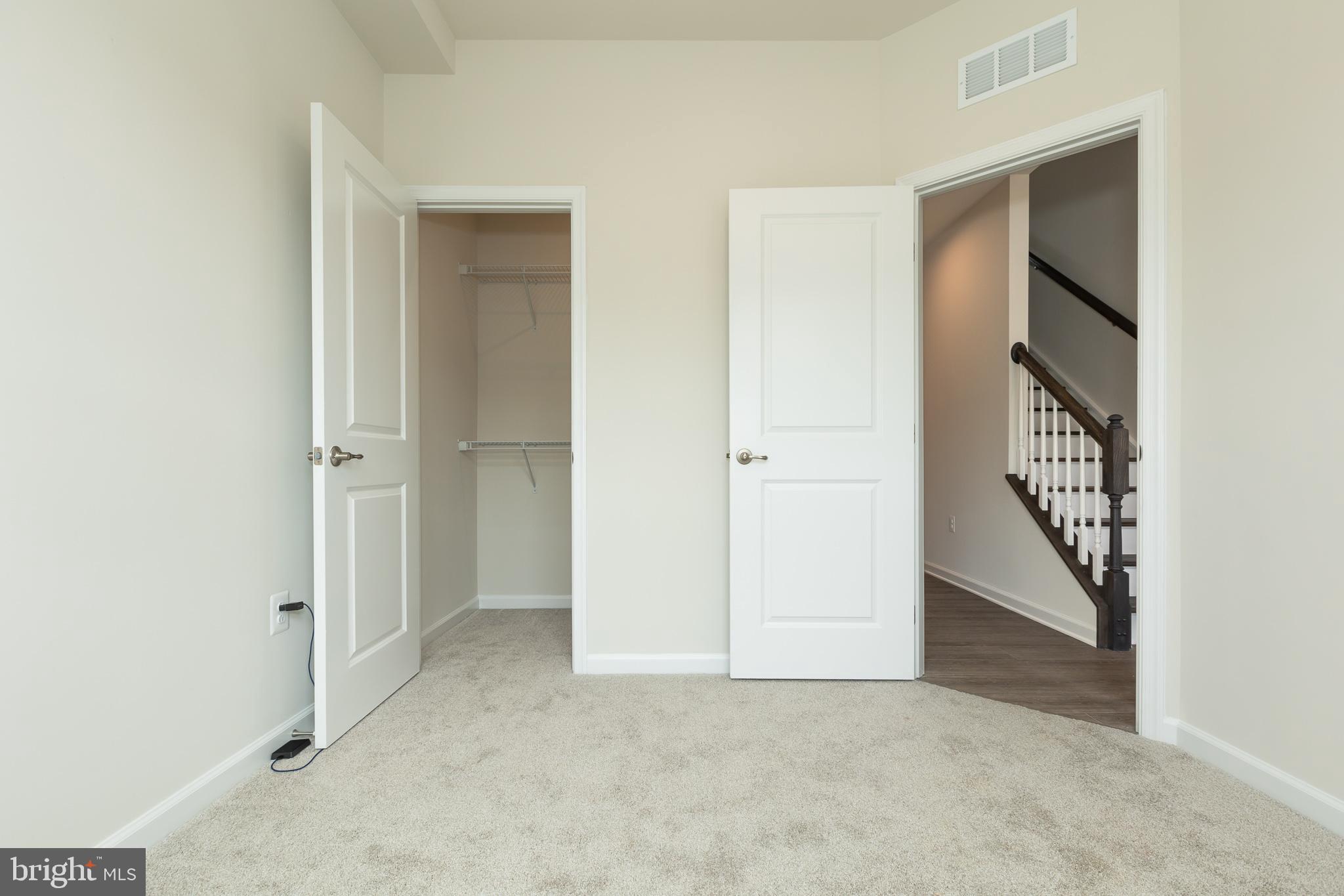 180 Woodgate Circle, Unit CLARENDON3 Pasadena, MD 21122 - Photo 12 of 47 an entryway with a hallway