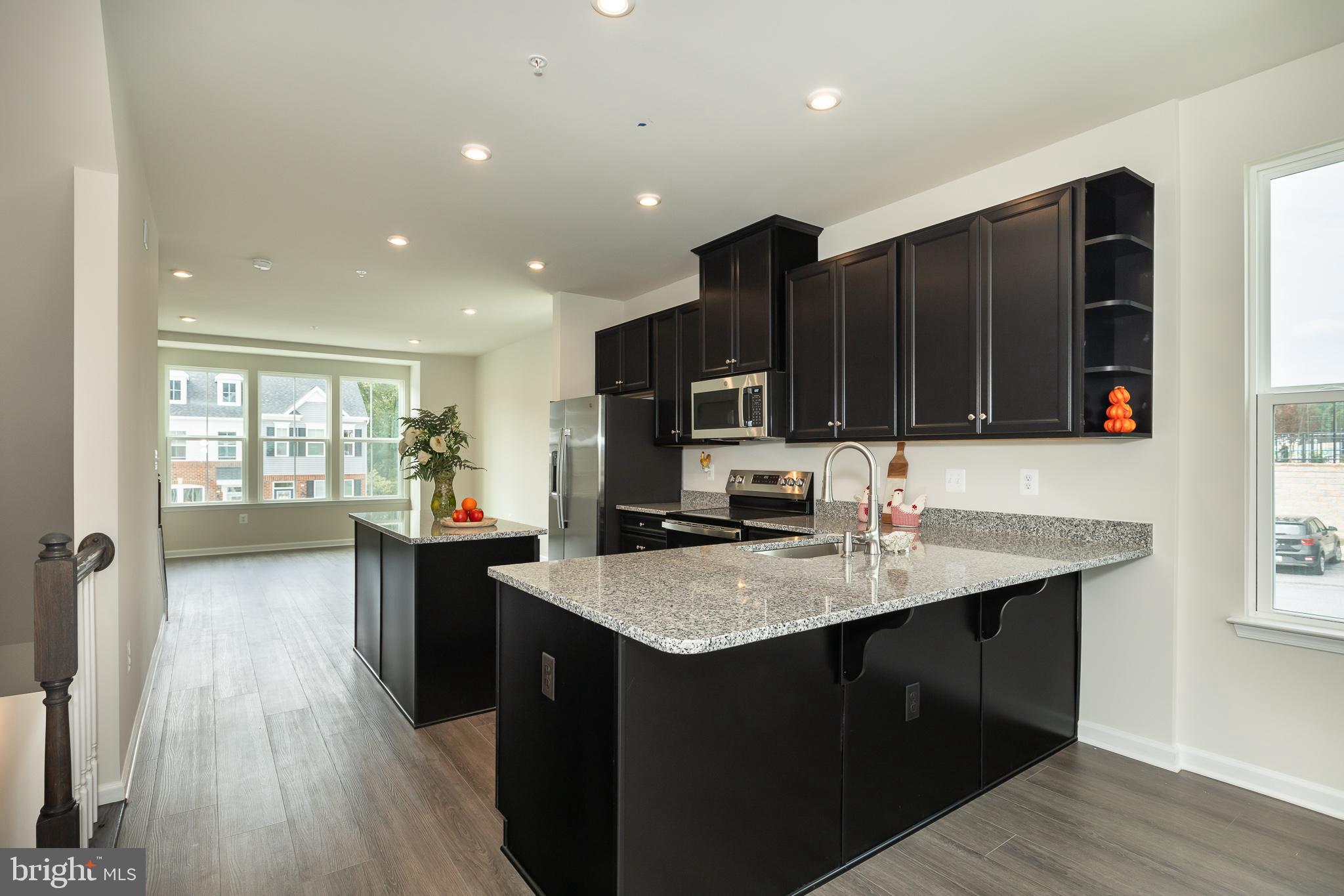 180 Woodgate Circle, Unit CLARENDON3 Pasadena, MD 21122 - Photo 23 of 47 a kitchen with a sink a counter top space and appliances