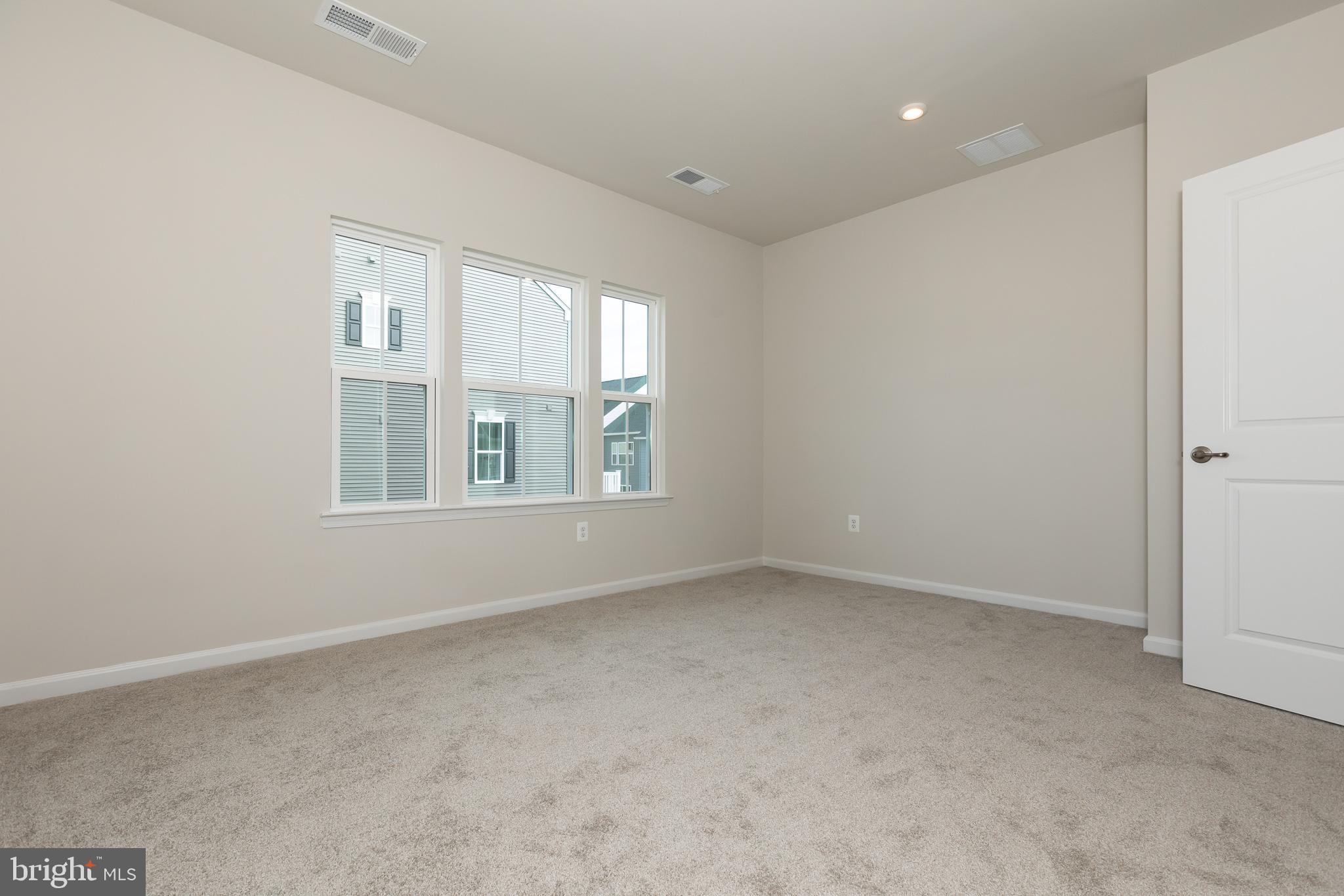 180 Woodgate Circle, Unit CLARENDON3 Pasadena, MD 21122 - Photo 35 of 47 an empty room with windows