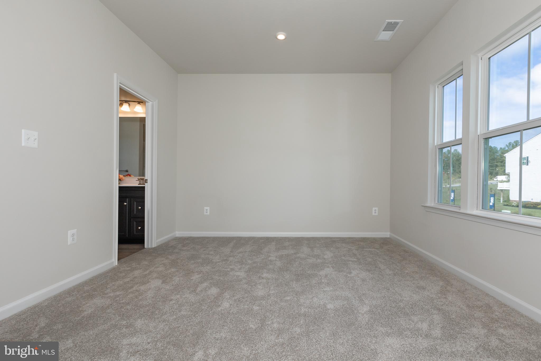 180 Woodgate Circle, Unit CLARENDON3 Pasadena, MD 21122 - Photo 37 of 47 an empty room with windows and closet