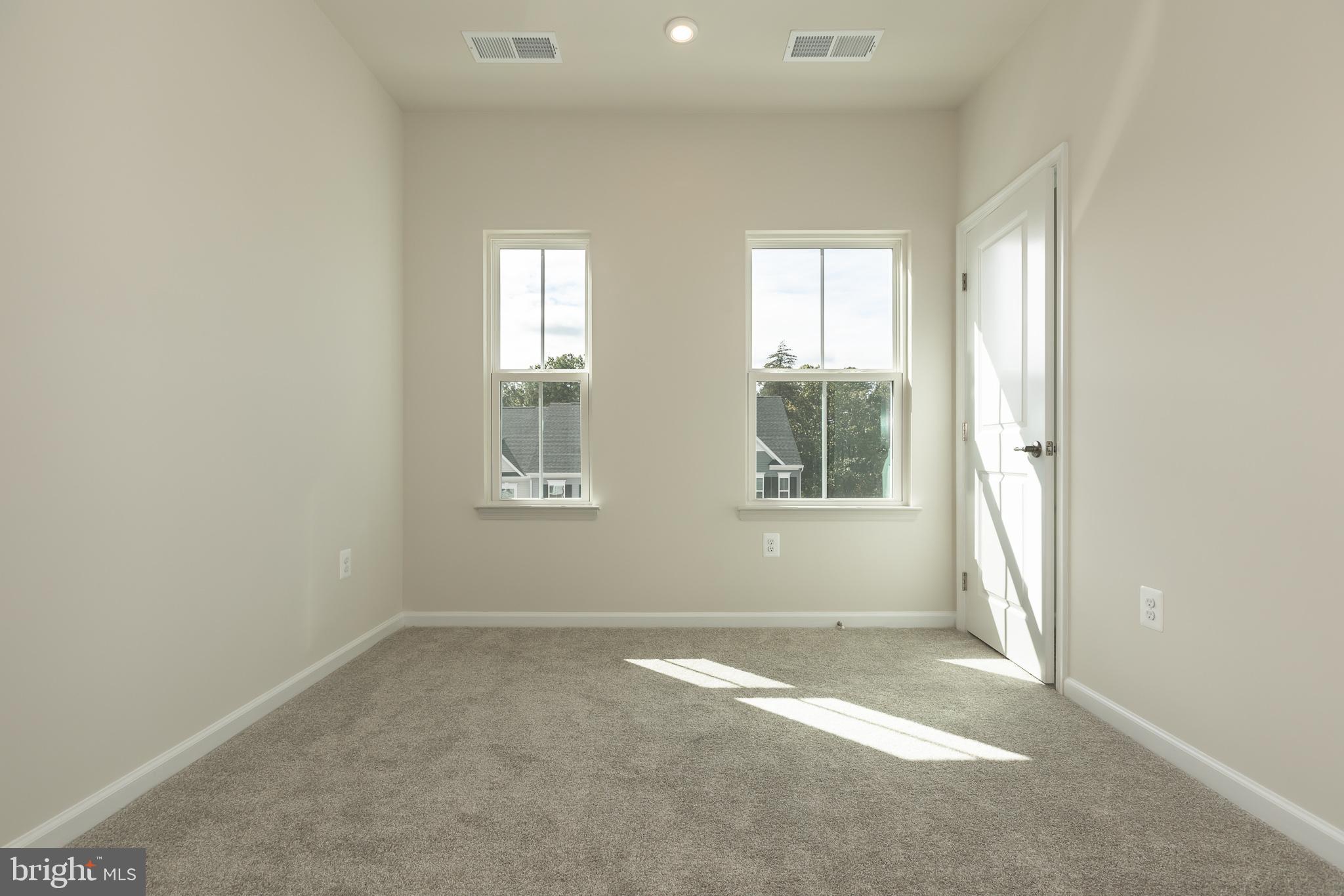 180 Woodgate Circle, Unit CLARENDON3 Pasadena, MD 21122 - Photo 41 of 47 an empty room with windows