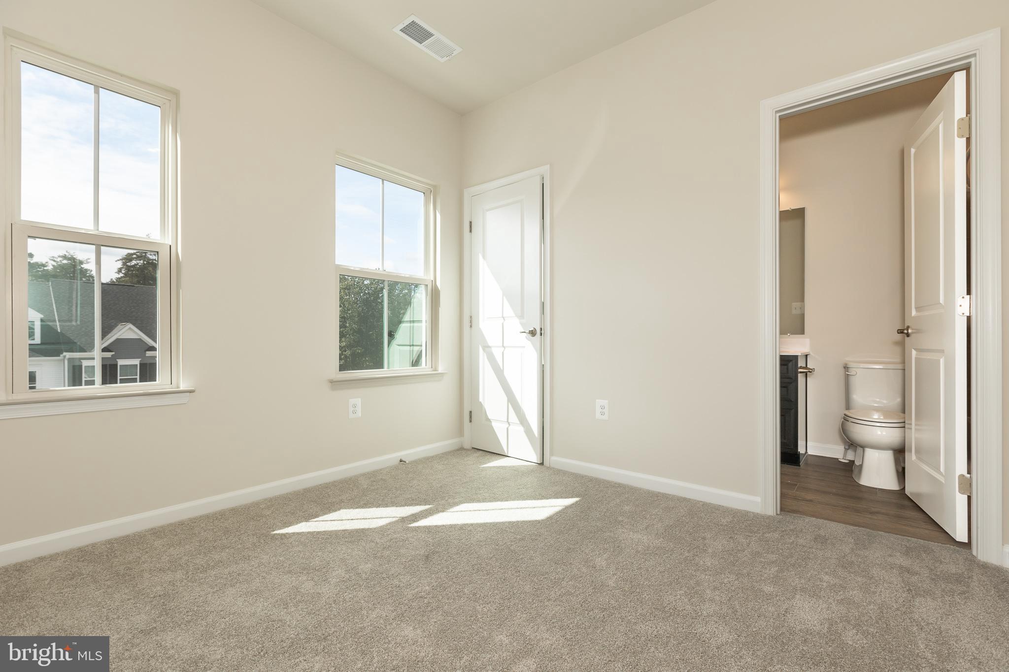 180 Woodgate Circle, Unit CLARENDON3 Pasadena, MD 21122 - Photo 42 of 47 a view of livingroom with hardwood floor and window
