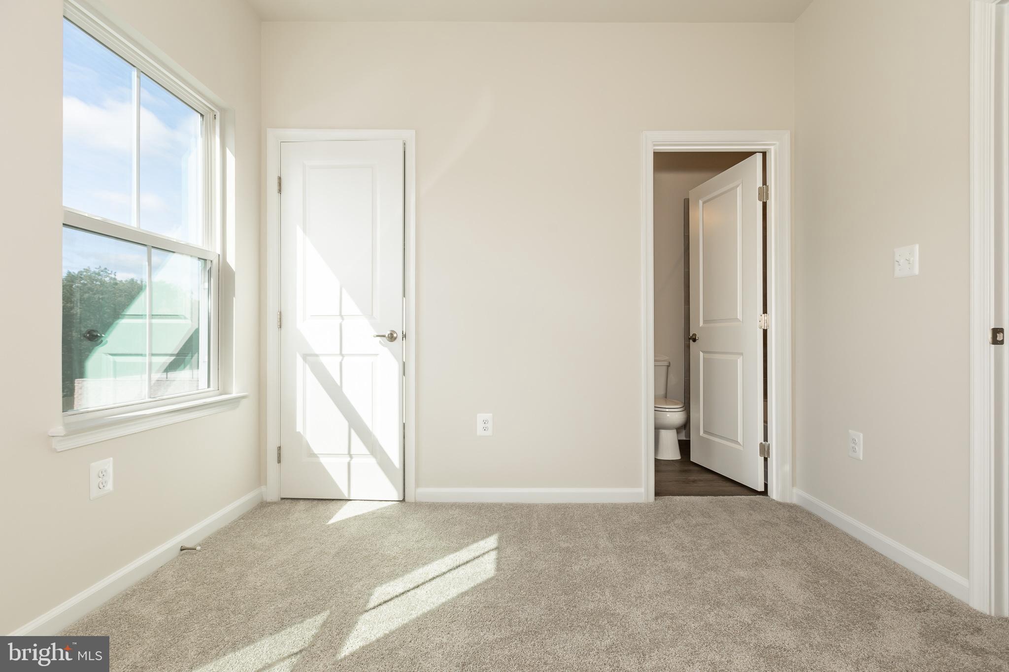 180 Woodgate Circle, Unit CLARENDON3 Pasadena, MD 21122 - Photo 43 of 47 an empty room with windows and closet