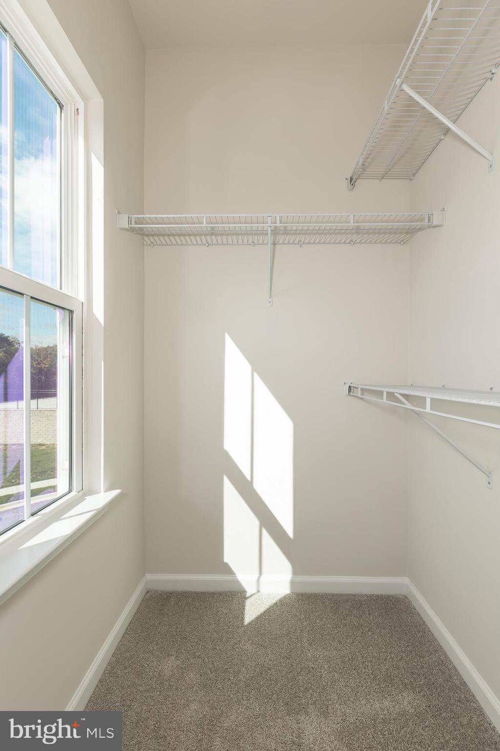 180 Woodgate Circle, Unit CLARENDON3 Pasadena, MD 21122 - Photo 45 of 47 a view of an empty room with a window