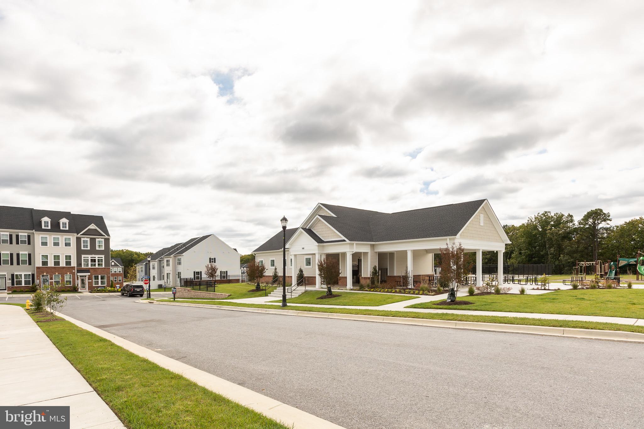 180 Woodgate Circle, Unit CLARENDON3 Pasadena, MD 21122 - Photo 7 of 47 a aerial view of a white house with a big yard and large trees