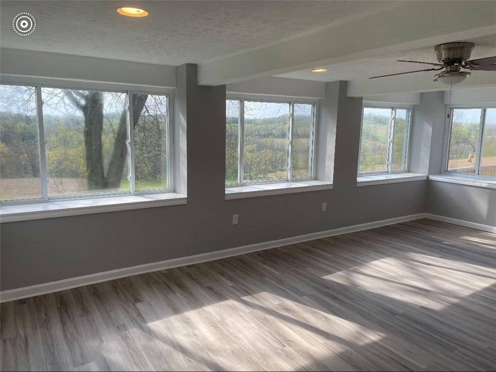93 Church Road Eighty Four, PA 15330 - Photo 8 of 14 a view of an empty room with a window and wooden floor