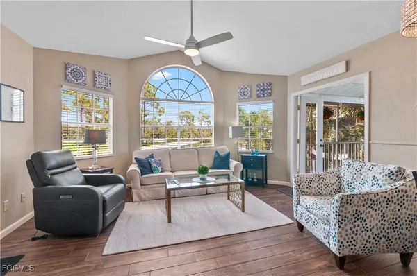 a living room with furniture and a large window
