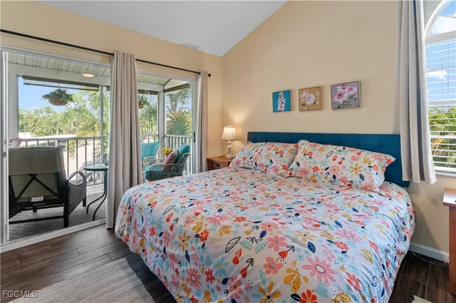 a bedroom with a bed and glass door