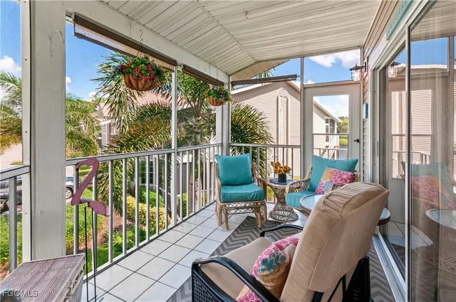 a view of a balcony with chairs and wooden floor
