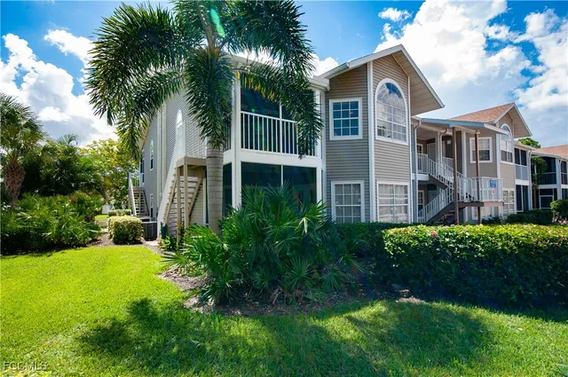 a view of a house with a yard and plants