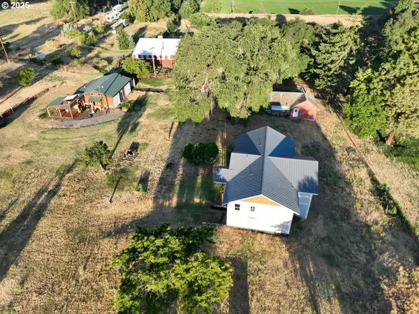 an aerial view of a house with a yard