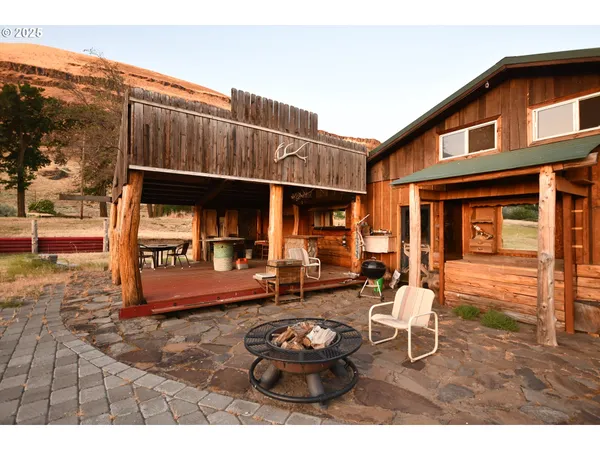 a backyard of a house with yard and outdoor seating