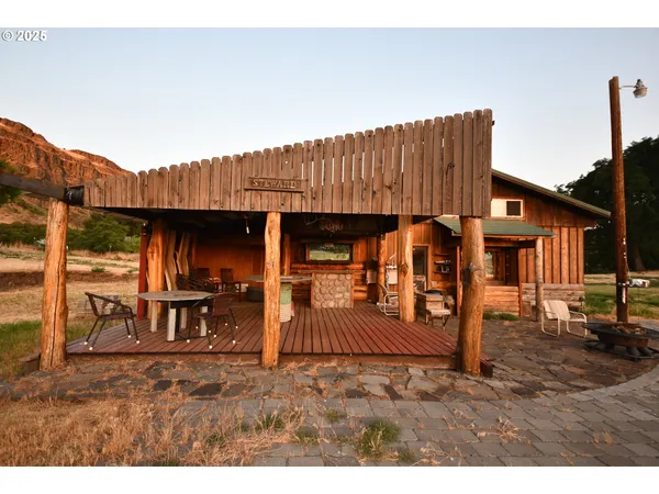 a view of a house with backyard and a patio