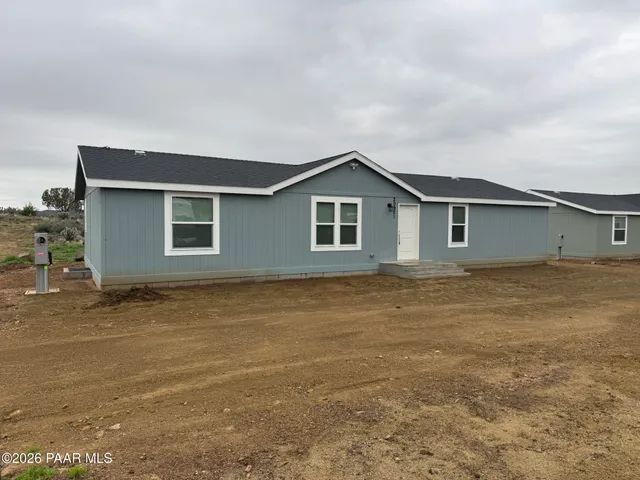 a view of an house with backyard space and balcony