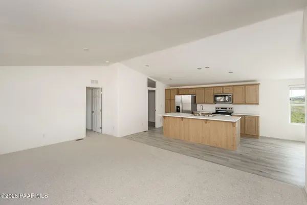 a view of kitchen with refrigerator and window