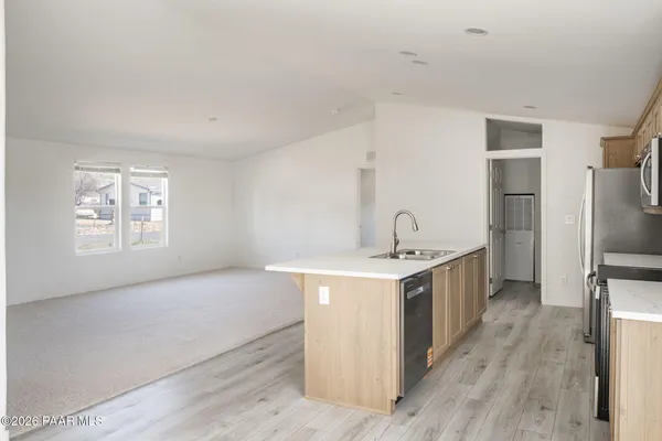 a kitchen with a sink stove and refrigerator