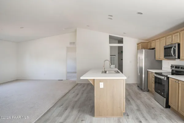 a kitchen with a stove top oven and sink