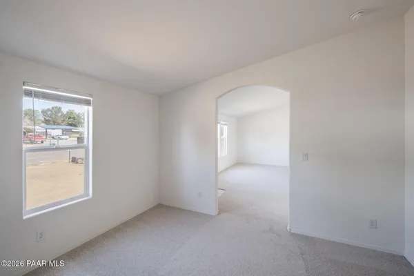 an empty room with windows and closet