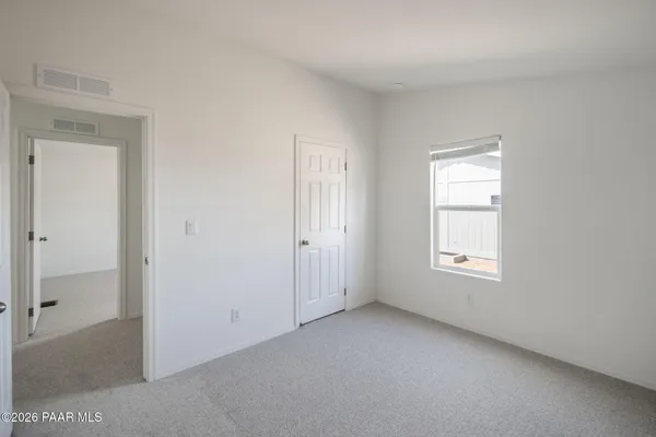 an empty room with windows and closet