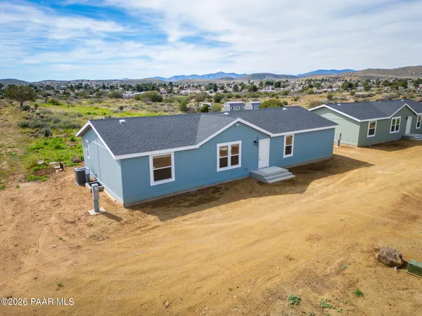 a view of a lake with houses in back