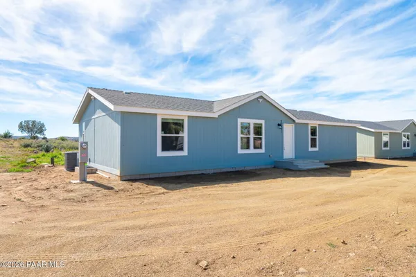 a view of a house with snow on the road