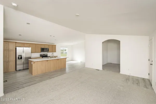 a view of kitchen with refrigerator cabinets and open kitchen view
