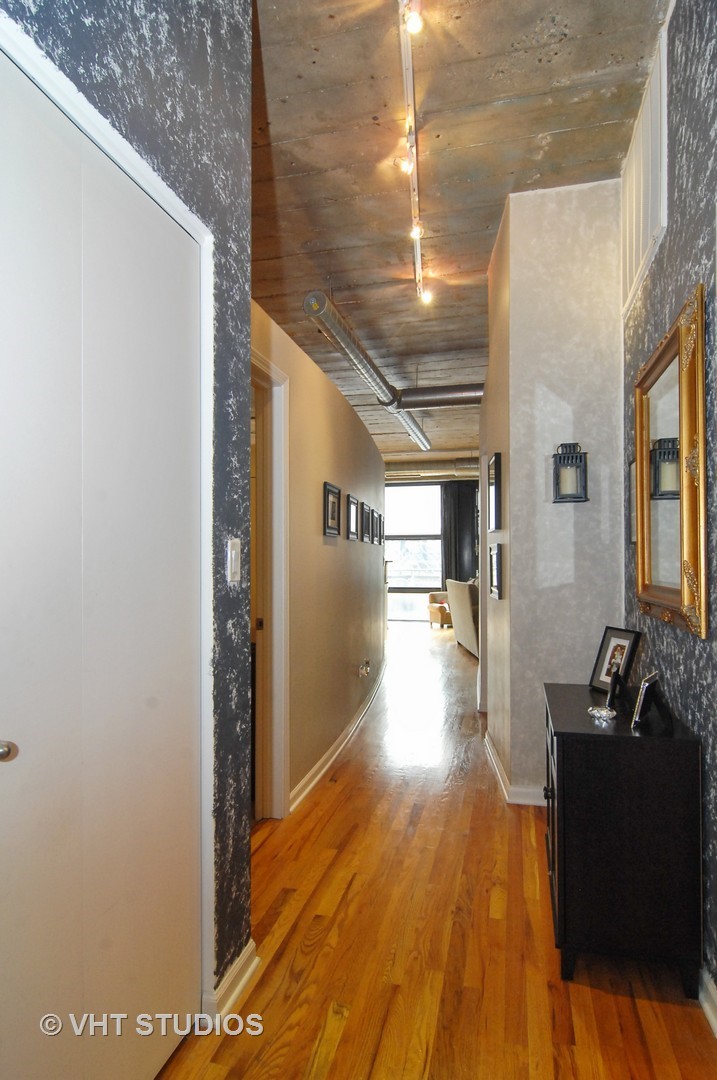 1000 West 15th Street, Unit 235 Chicago, IL 60608 - Photo 13 of 16 a view of a hallway with wooden floor