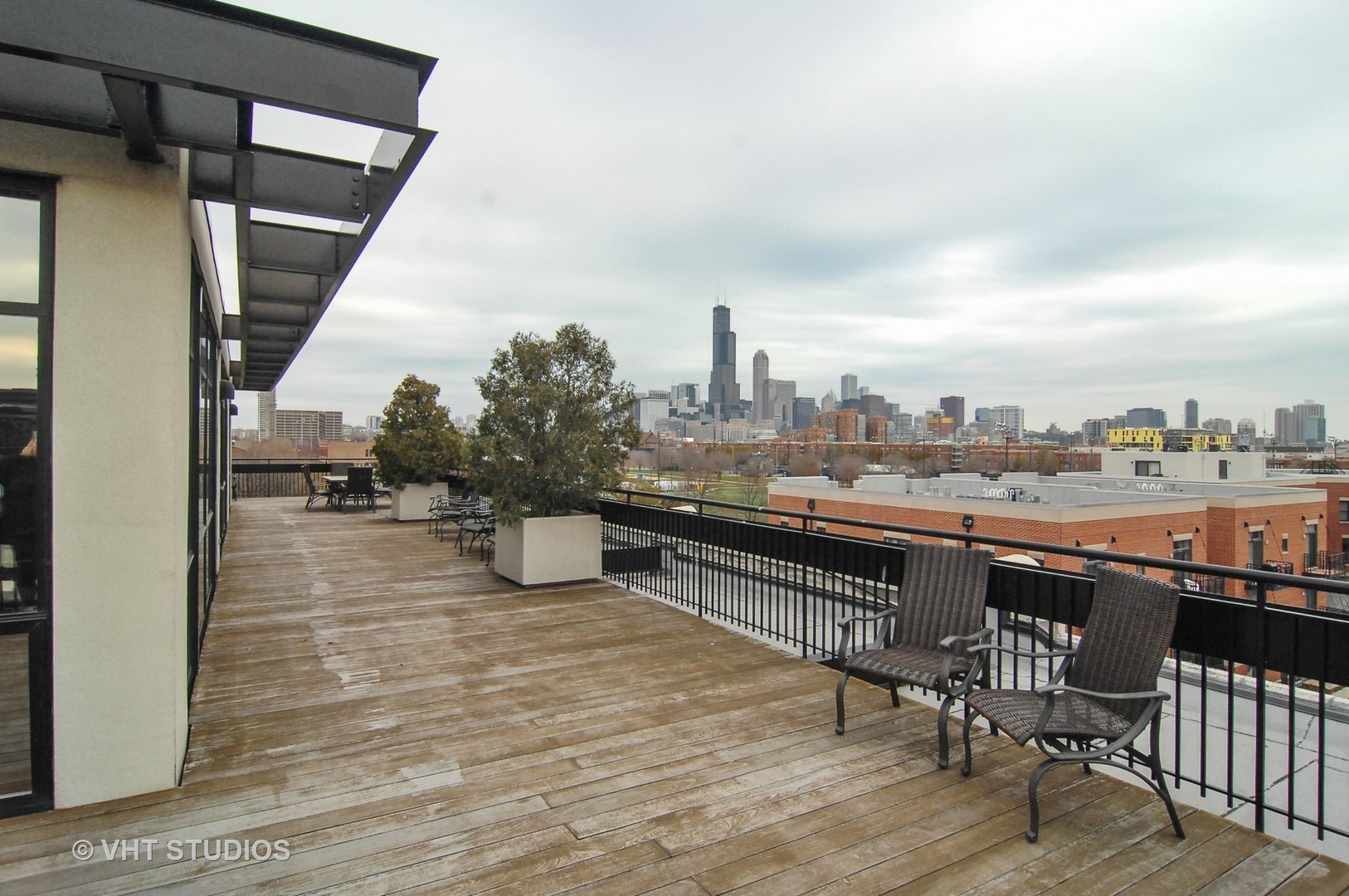 1000 West 15th Street, Unit 235 Chicago, IL 60608 - Photo 15 of 16 a view of roof deck with seating space and wooden floor