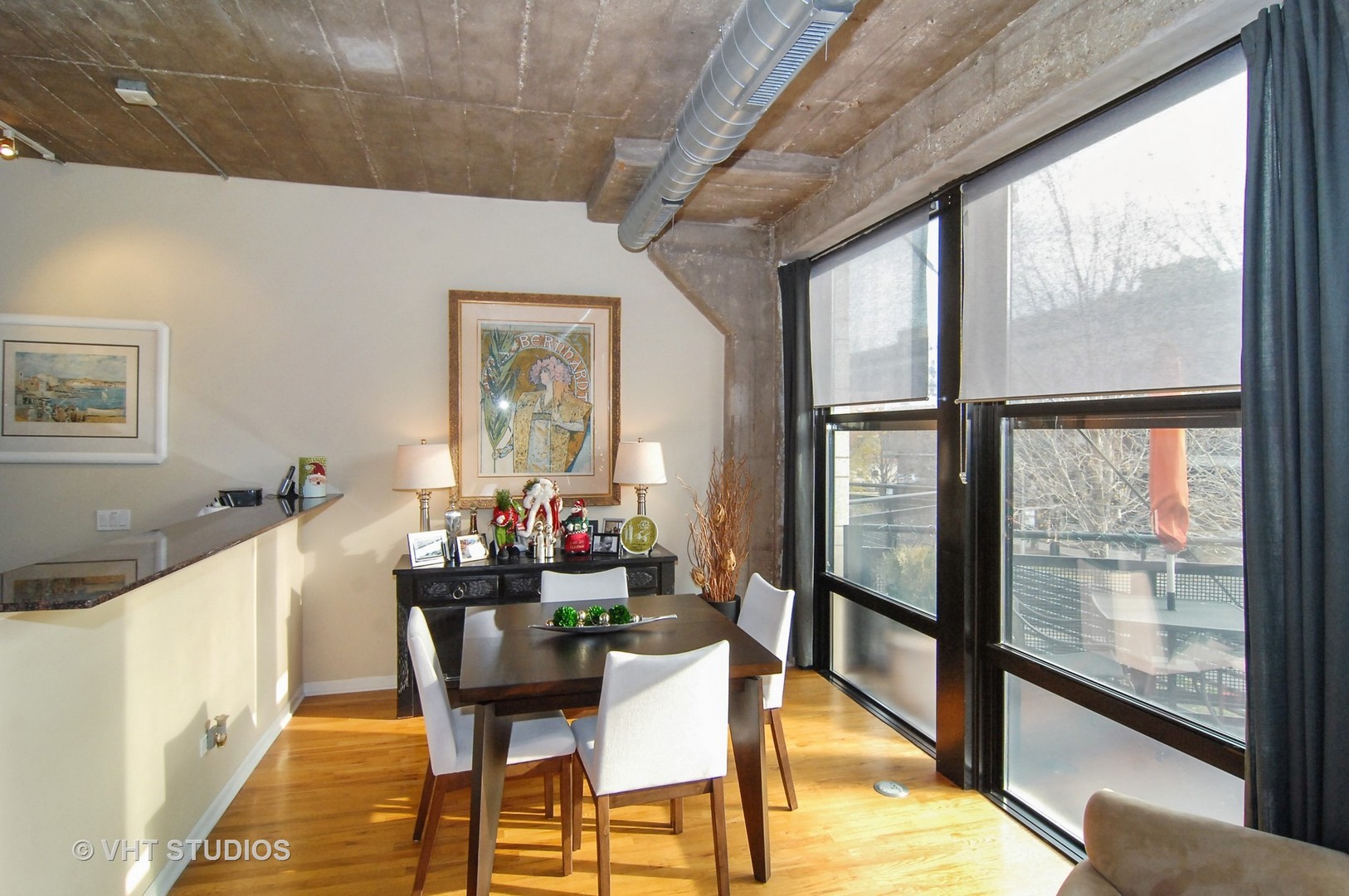 1000 West 15th Street, Unit 235 Chicago, IL 60608 - Photo 3 of 16 a view of a dining room with furniture a chandelier and wooden floor
