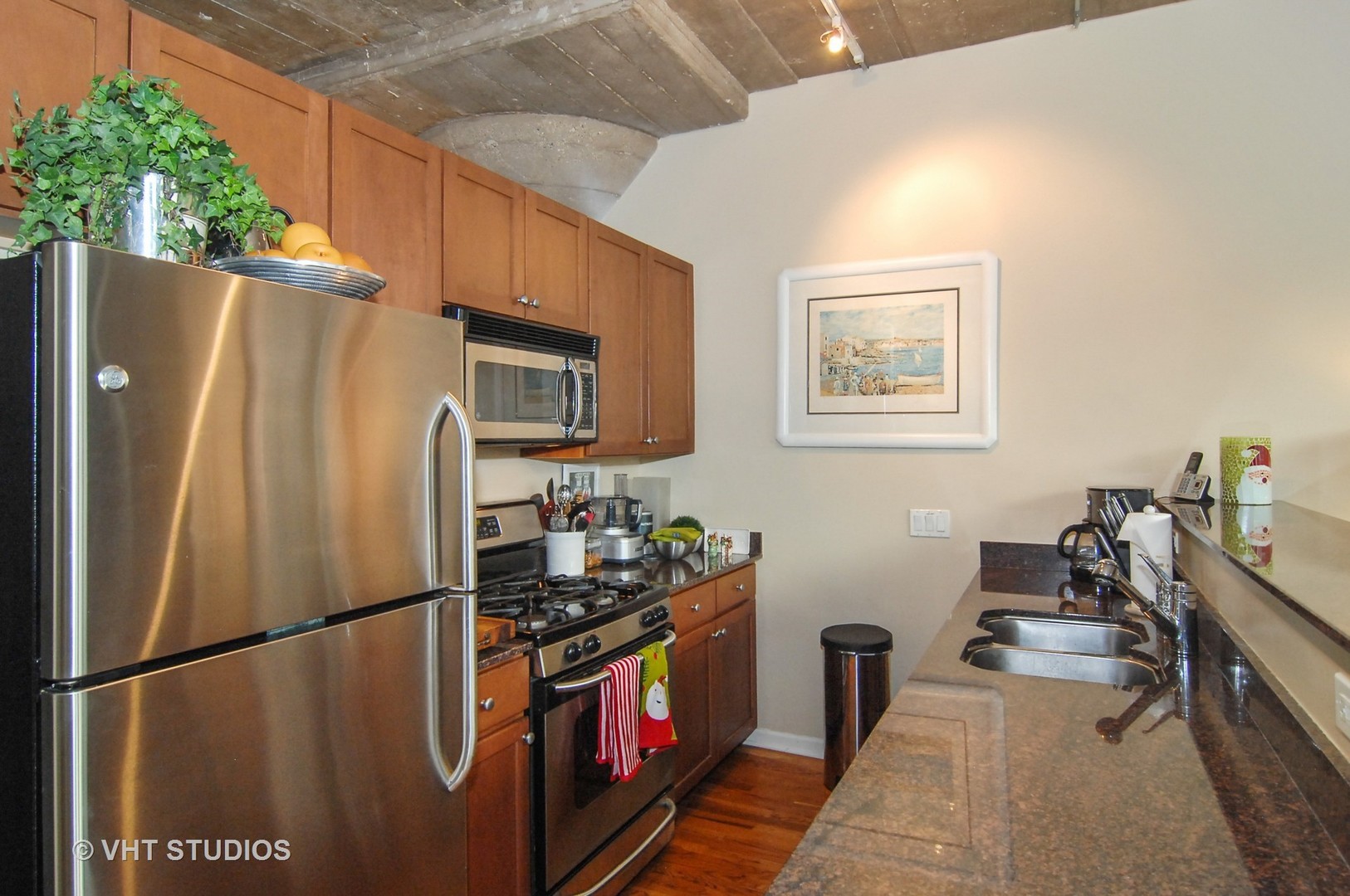1000 West 15th Street, Unit 235 Chicago, IL 60608 - Photo 5 of 16 a kitchen with stainless steel appliances a refrigerator a stove a microwave a sink and dishwasher
