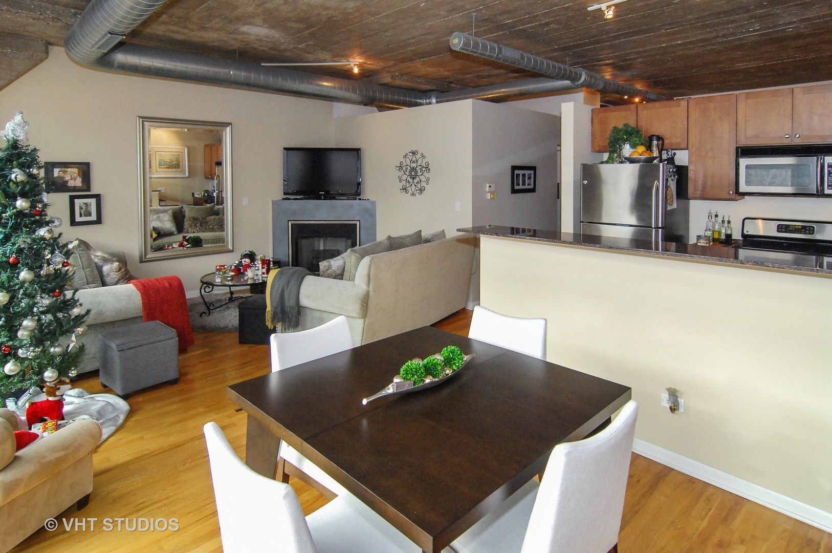 1000 West 15th Street, Unit 235 Chicago, IL 60608 - Photo 6 of 16 a living room with furniture and a flat screen tv
