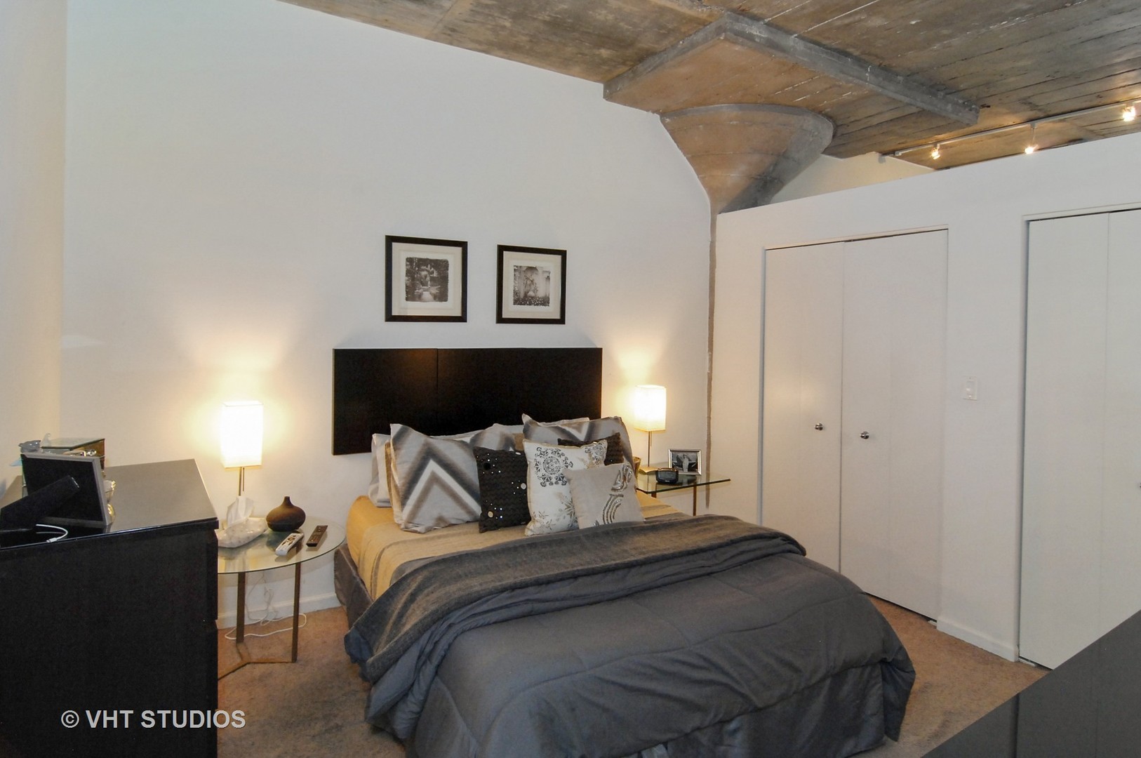 1000 West 15th Street, Unit 235 Chicago, IL 60608 - Photo 9 of 16 a bedroom with a bed and a night stand