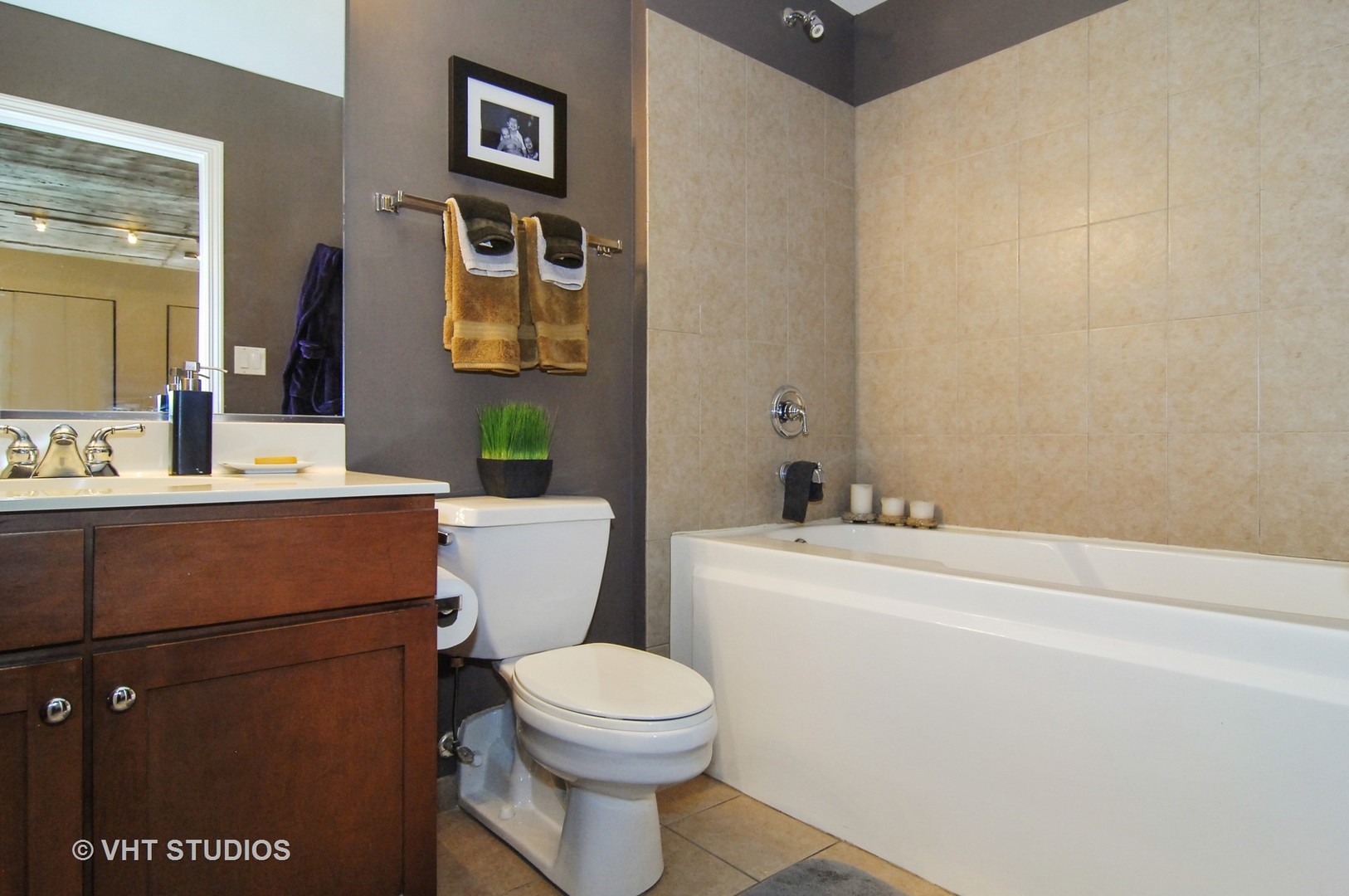 1000 West 15th Street, Unit 235 Chicago, IL 60608 - Photo 10 of 16 a bathroom with a toilet a sink and a mirror